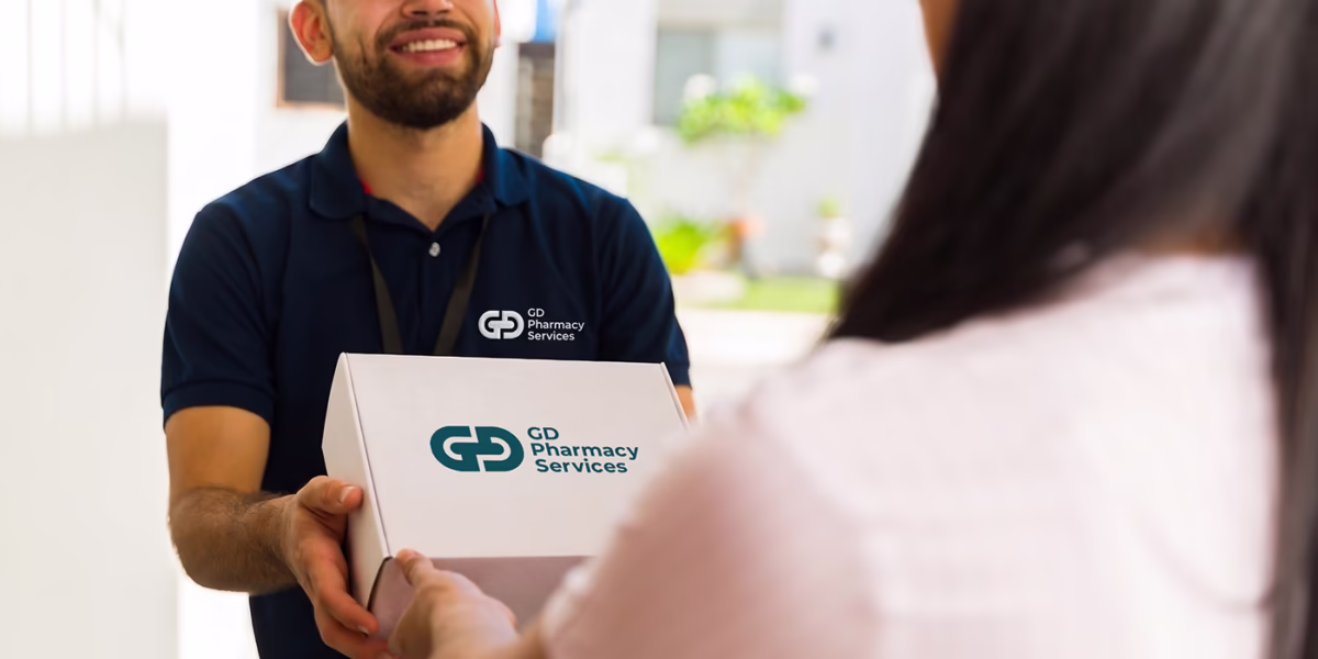 A GD Pharmacy Services team member delivering a prescription to a patient